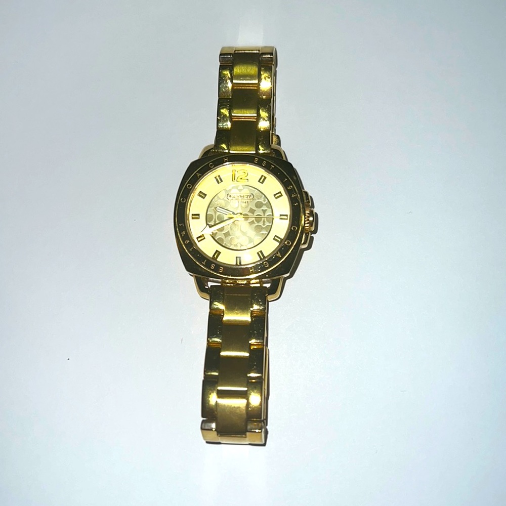 Gold coach watch, wrist size adjusters included